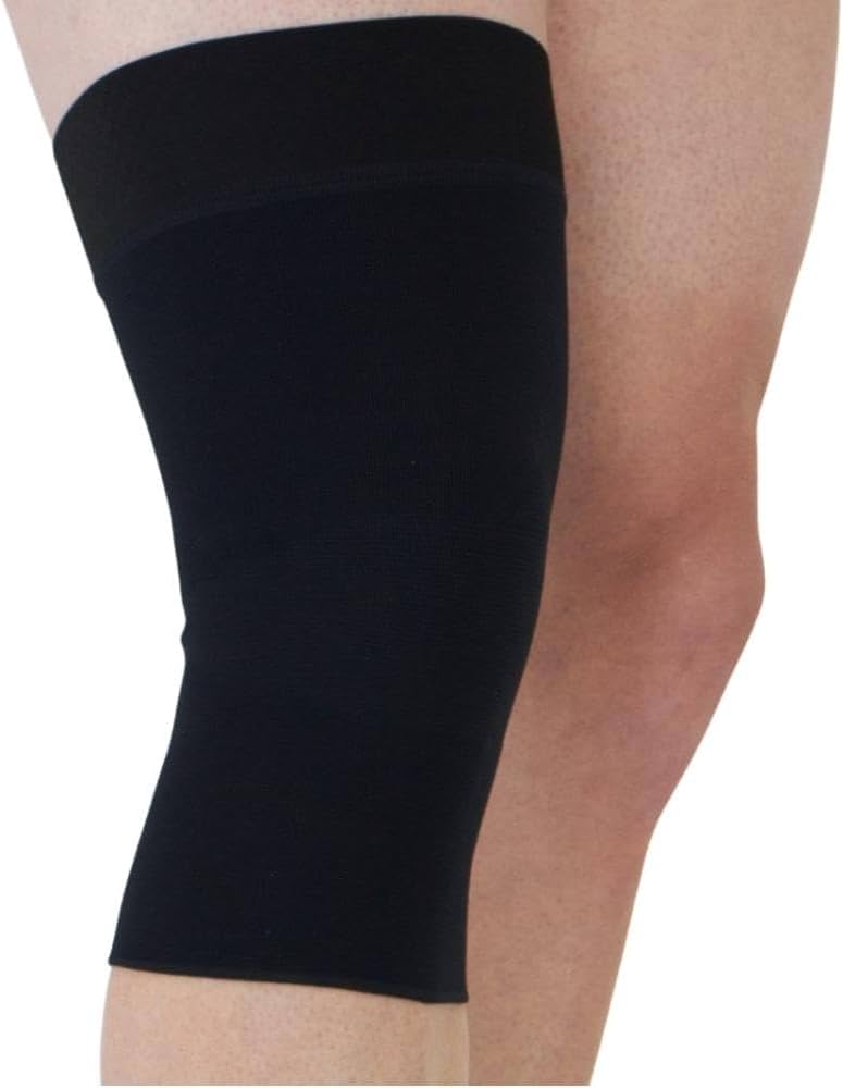 Knee sleeve support in black seamless fabric worn on a person's left knee, shown against a white background