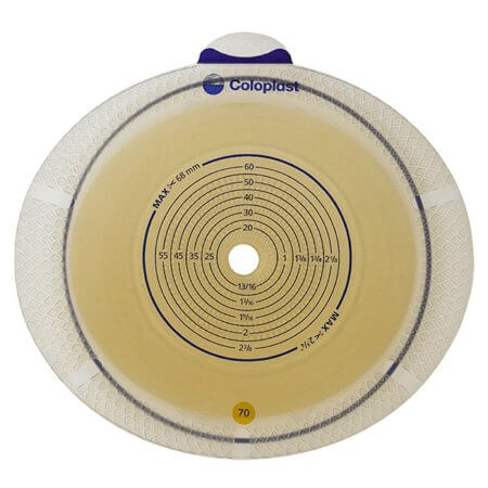 Ostomy barrier wafer with circular cutting guide measurements printed in blue on a round adhesive flange with center stoma