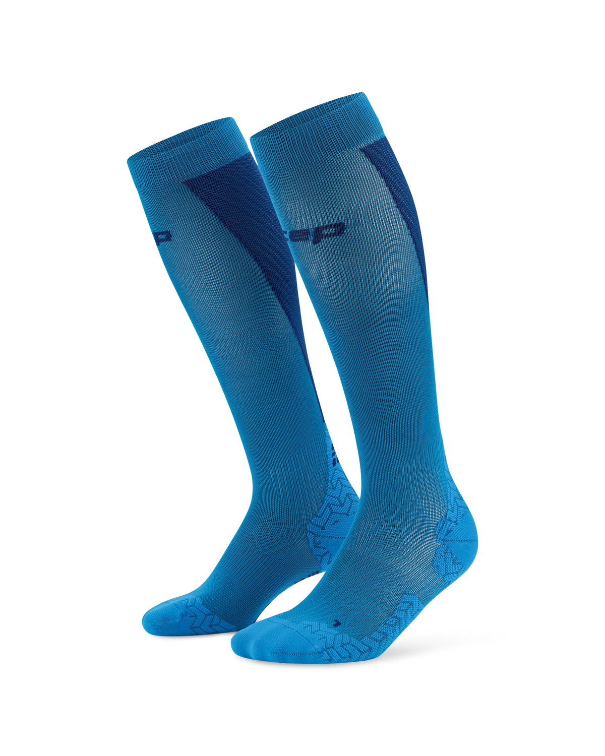Compression knee-high socks in blue with navy accent panels and geometric foot detailing, shown as a standing pair