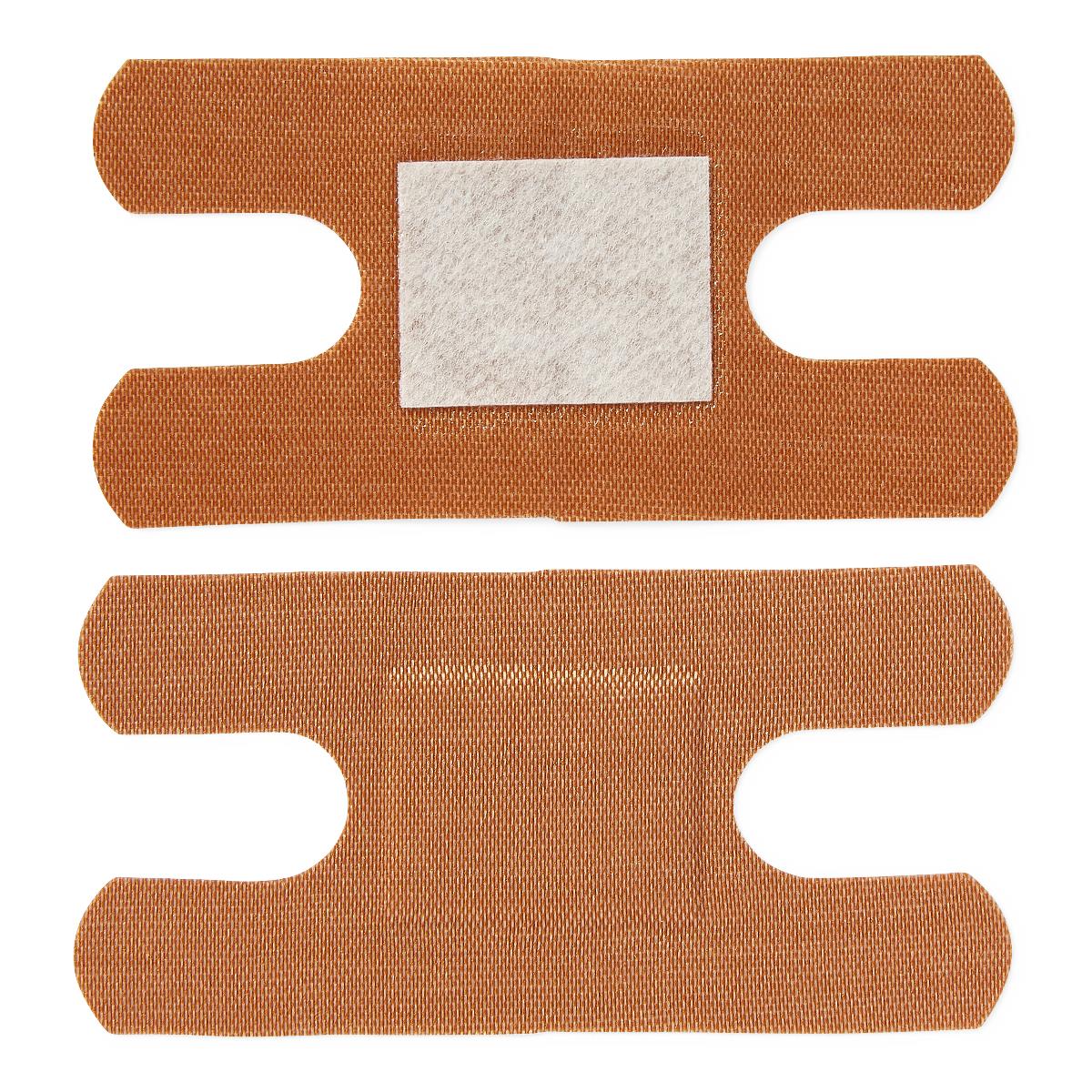 Fabric adhesive bandages shown front and back, tan woven texture with white absorbent pad visible on front side
