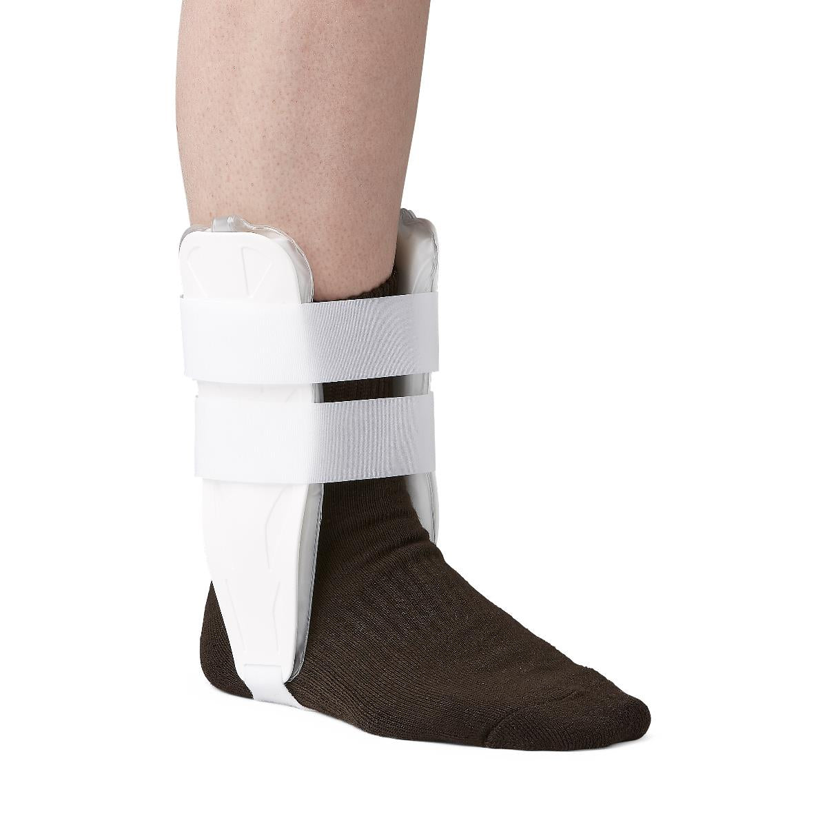 Stirrup ankle splint with air bladders worn on left foot over dark sock, white rigid shell with two hook-and-loop straps