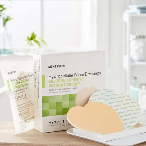 McKesson hydrocellular foam dressing box with silicone adhesive sacral dressing shown front and back beside individual