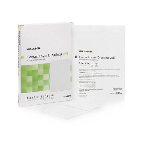 Contact layer wound dressing box and individual sterile packet, white with green accent, shown front and back
