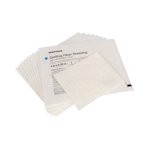 Gelling fiber wound dressings in individual sterile packaging, fanned out to show multiple units with one pad displayed in