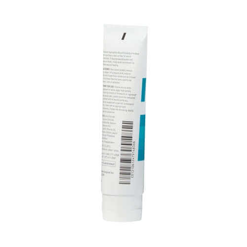 Wound dressing gel in a white squeeze tube with teal accents, showing back label with barcode and instructions