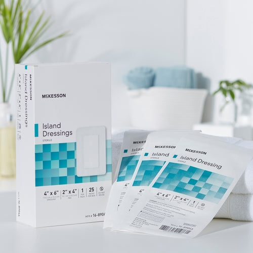 McKesson Island Dressings box with individual sterile packaging packets displayed on a white surface in a bathroom setting.