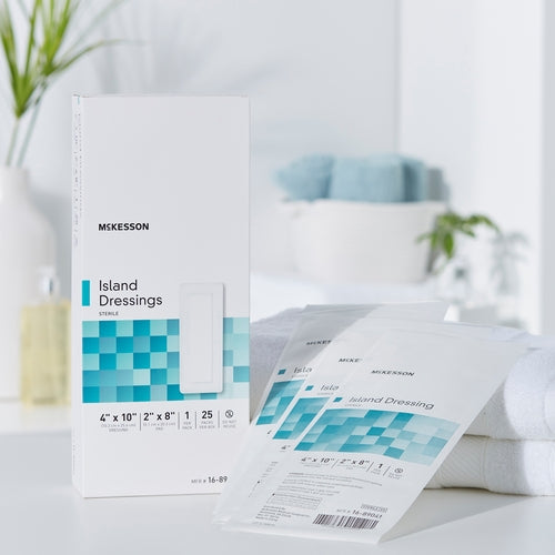 McKesson Island Dressings box with individually packaged sterile dressings fanned out beside it on a white surface