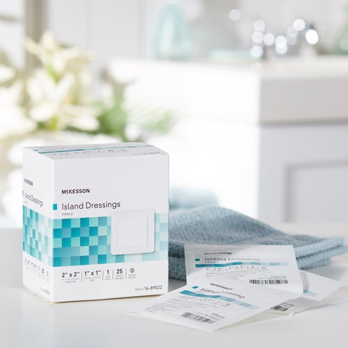 McKesson Island Dressings box with individual sterile dressing packets on a white countertop beside a blue towel