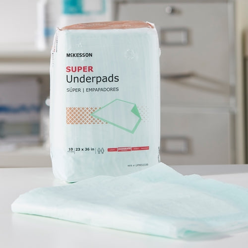 McKesson Super Underpads package of 10 displayed upright with a single light green pad unfolded in front