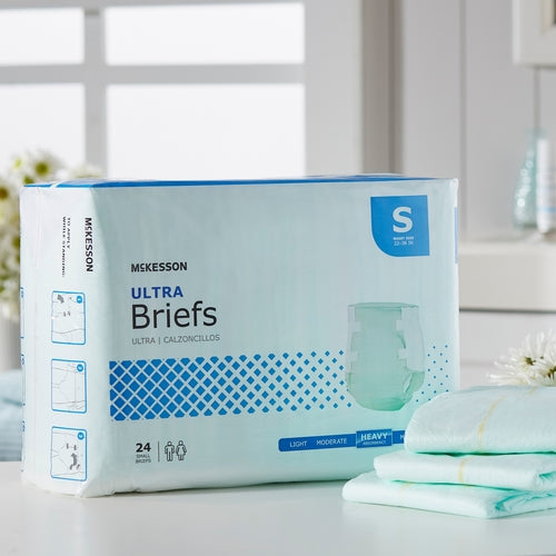 McKesson Ultra Briefs incontinence brief package in small size with heavy absorbency, displayed beside folded briefs on a