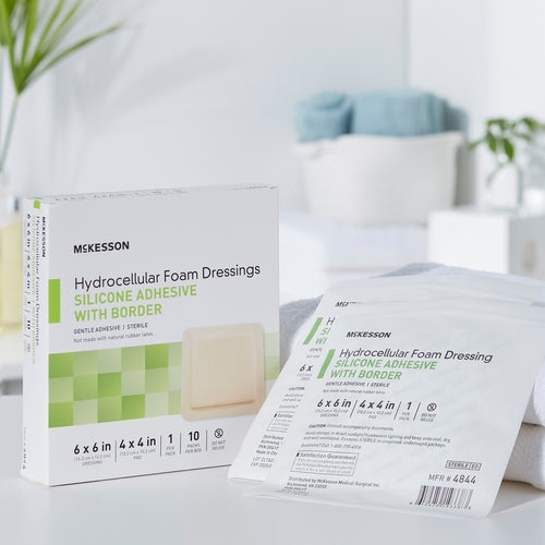McKesson hydrocellular foam dressing box with silicone adhesive border beside individual sterile packaging pouches