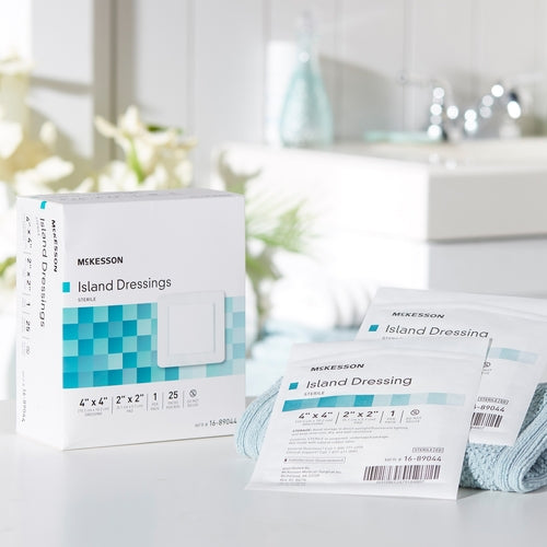 McKesson island dressings box of 25 with individual sterile packets displayed on a white bathroom counter surface