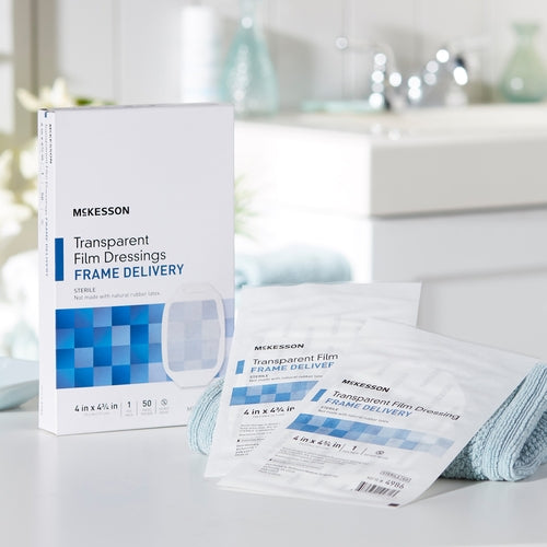 McKesson transparent film dressing box with two individual sterile packets displayed on a white countertop in a bathroom