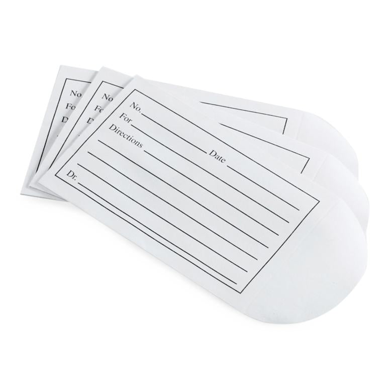 Medication envelopes with printed prescription label fields for No., For, Directions, Date, and Dr., fanned out showing