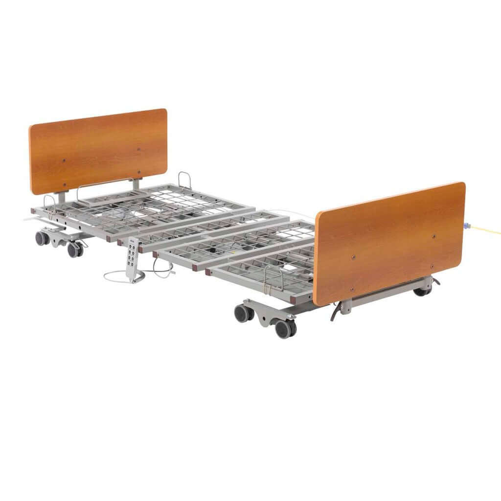 Electric hi-low hospital bed with wood-tone head and footboards, metal spring deck, caster wheels, and hand control pendant