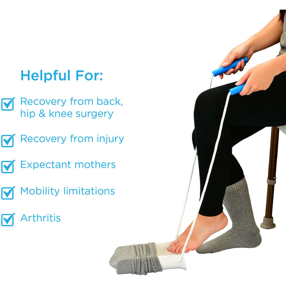 Sock aid with blue foam handles and white cradle being used by seated person to put on a gray sock without bending