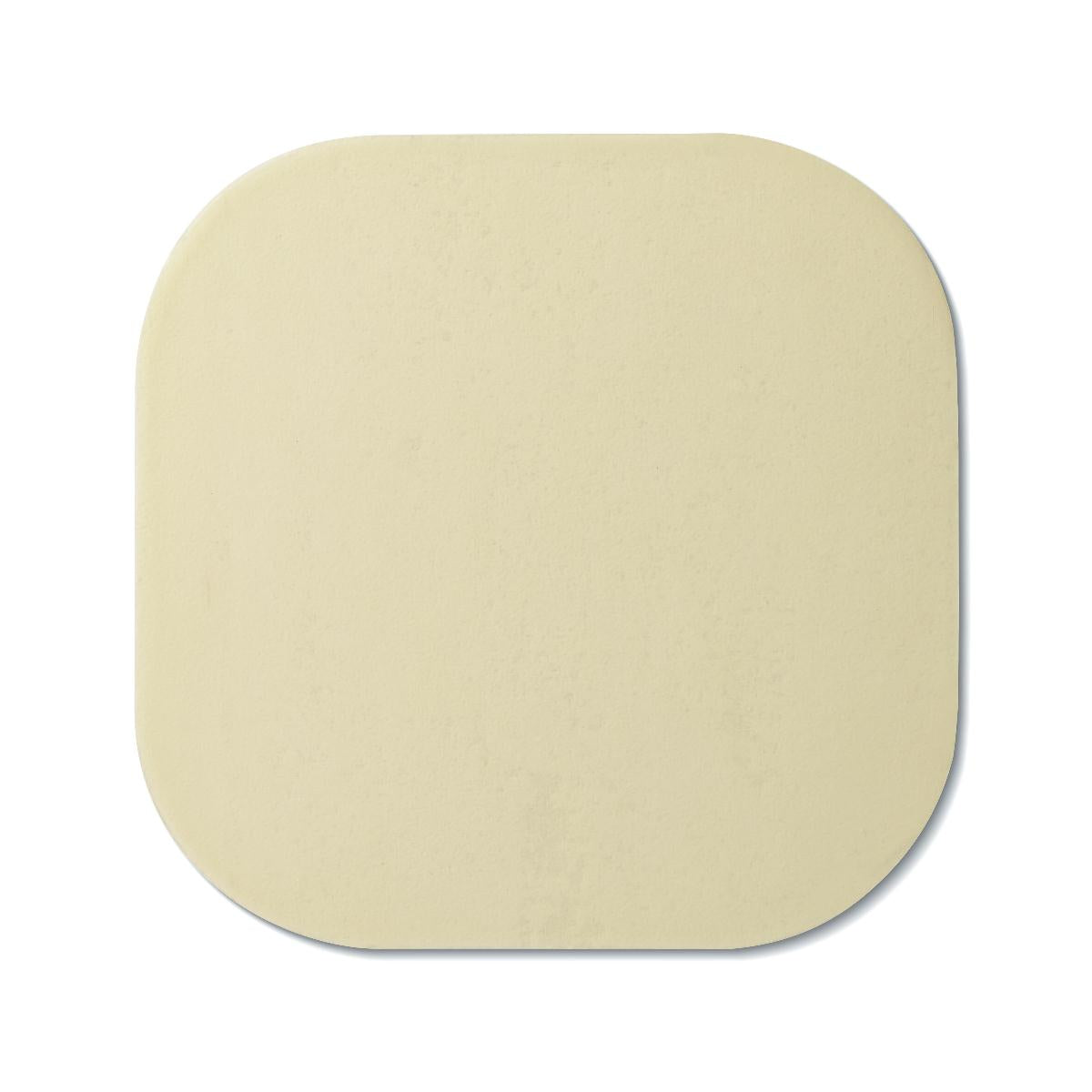 Hydrocolloid wound dressing, square with rounded corners, thin and flat in cream color, shown on white background
