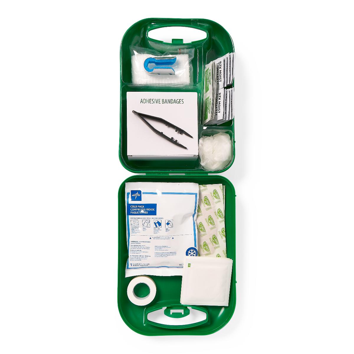 First aid kit open green hard case showing adhesive bandages, cold pack, gauze, medical tape, and assorted wound care