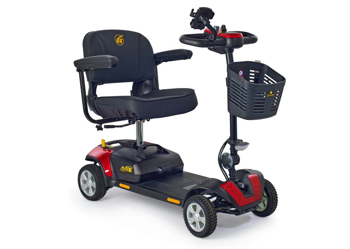Four-wheel electric mobility scooter in red and black with padded seat, armrests, tiller steering, and front storage basket