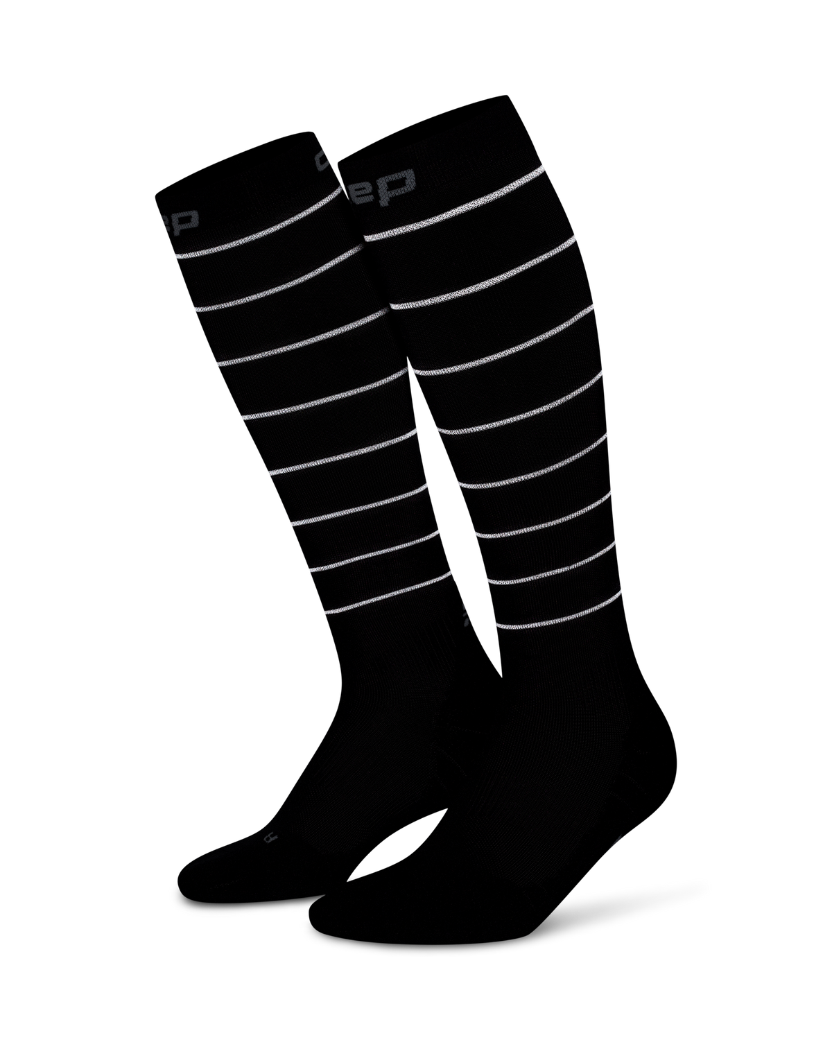 Compression knee-high socks in black with reflective horizontal stripes and a branded cuff, shown as a pair