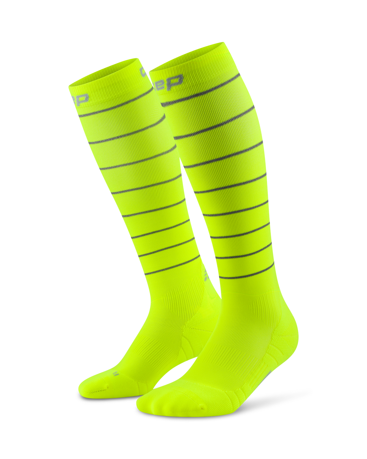 Compression knee-high socks in neon yellow with gray reflective horizontal stripes, shown as a pair