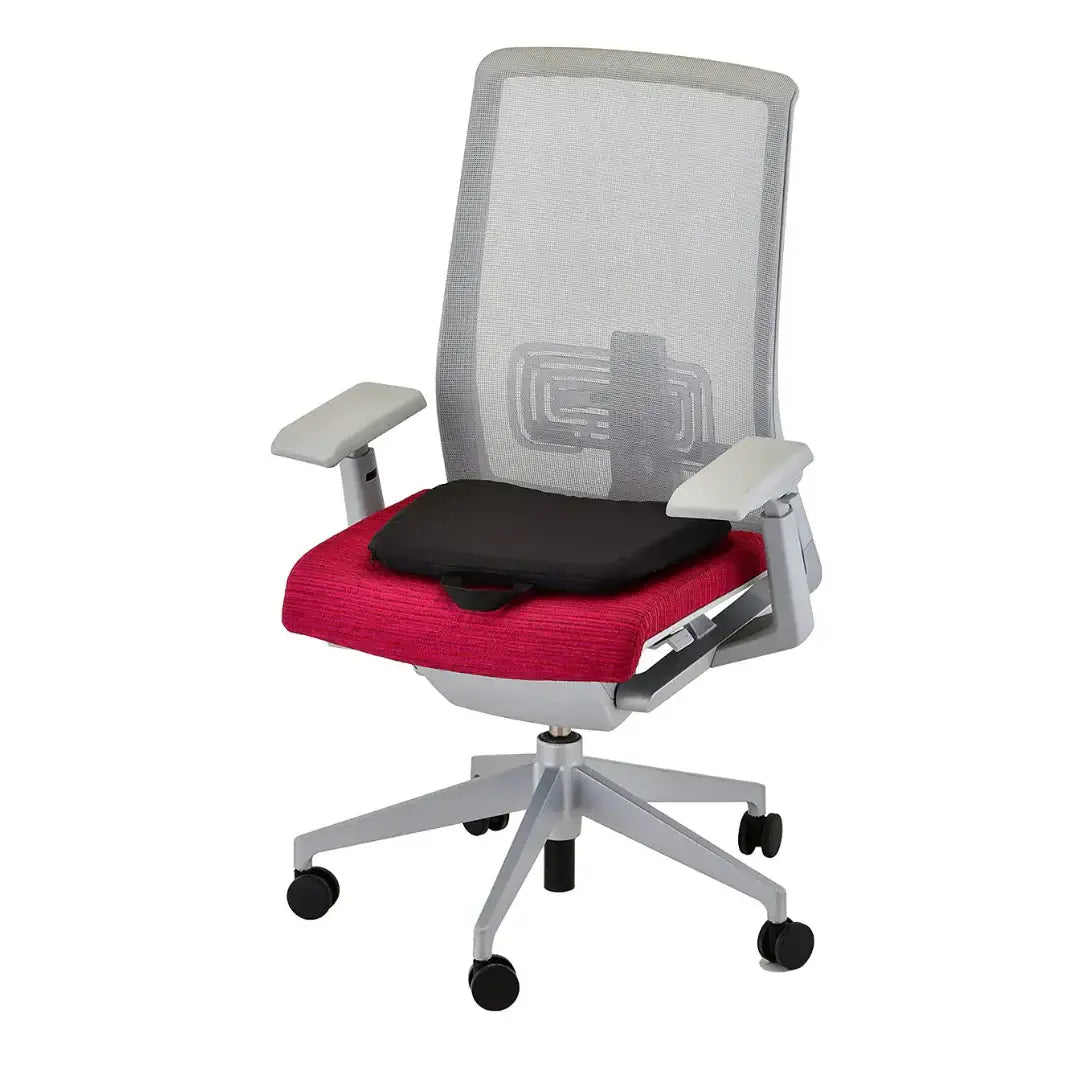 Seat cushion in black placed on a red office chair with gray mesh back and armrests