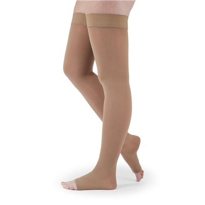 Compression thigh-high stockings in beige with silicone top band and open toe, shown on legs against white background