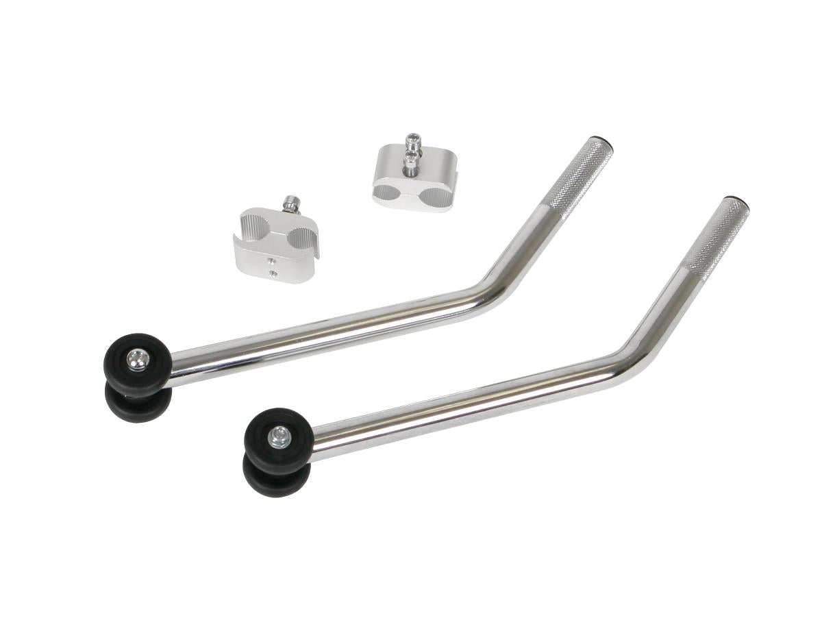 Wheelchair anti-tip device kit with two chrome-finished angled tubes, black rubber wheels, and two aluminum mounting brackets