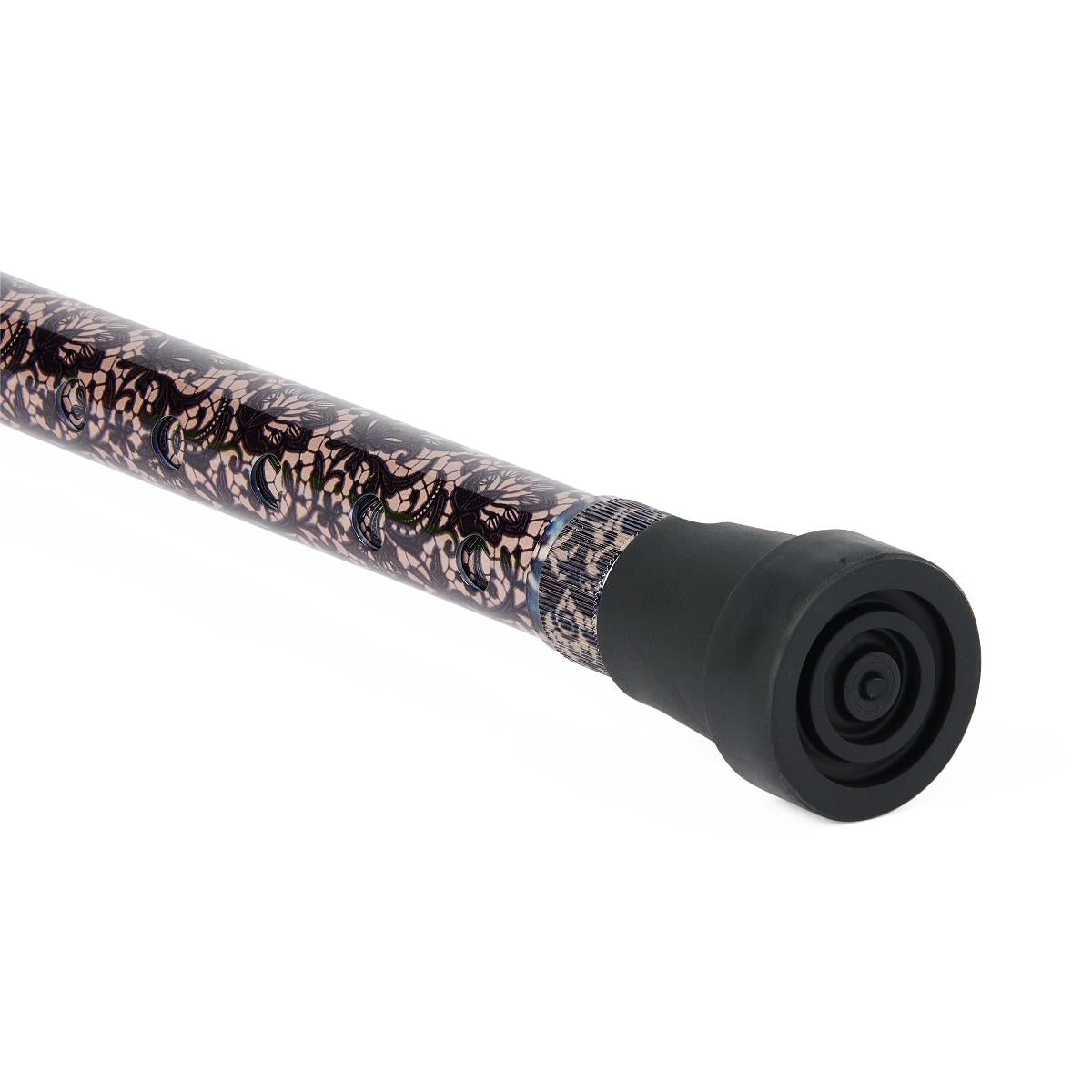 Walking cane shaft with black lace floral pattern on beige background, showing black rubber tip end closeup