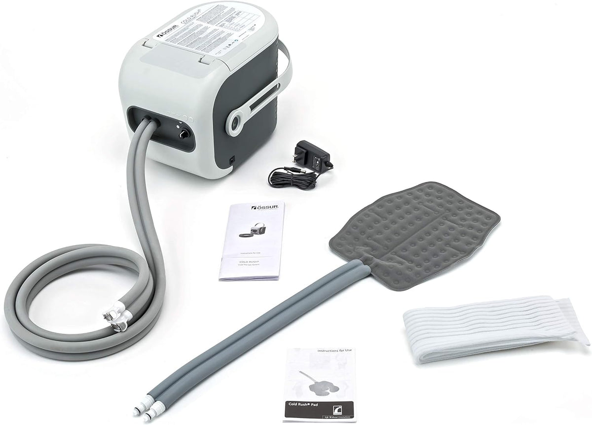 Cold therapy machine system with motorized unit, gray tubing, textured therapy pad, power adapter, wraps, and instruction
