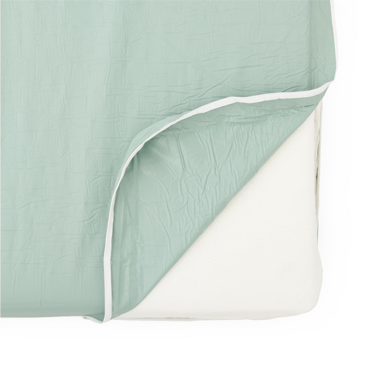 Foam mattress with corner folded back showing sage green fabric top layer and white foam interior