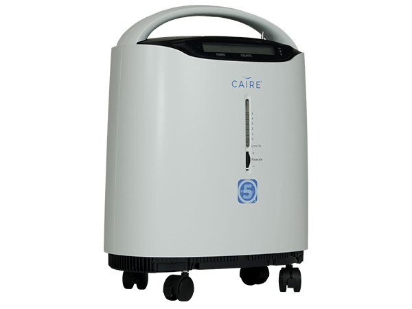 Caire stationary oxygen concentrator with carry handle, flow rate indicator, digital display, and four rolling casters on