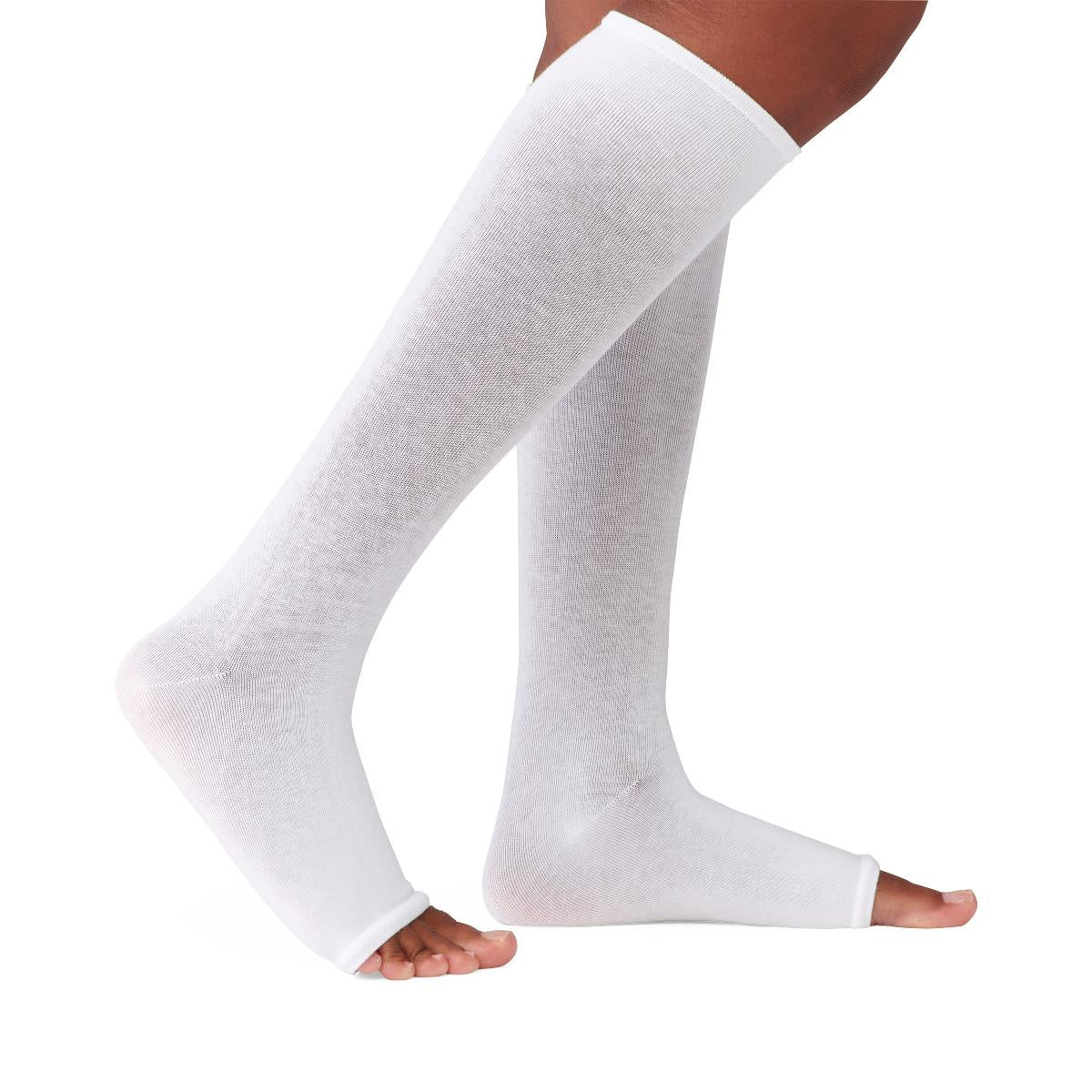 Compression leg sleeves in white, knee-high with open toe and heel design, worn on both legs against white background
