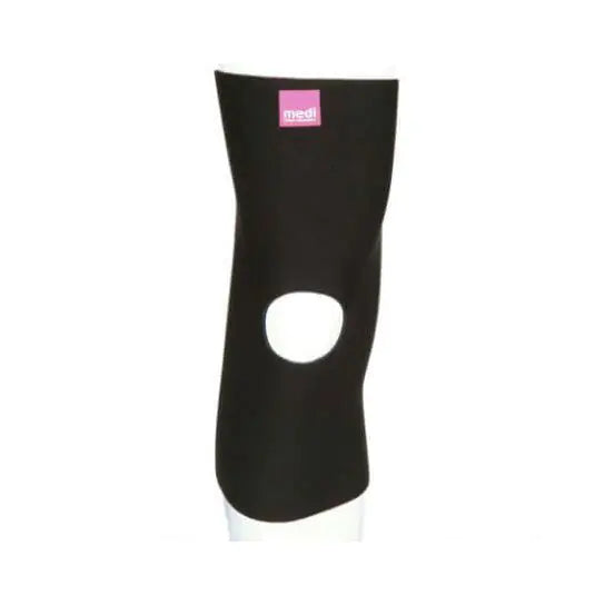 Knee support sleeve in black neoprene with open patella design, shown on a leg form, with pink brand label at top