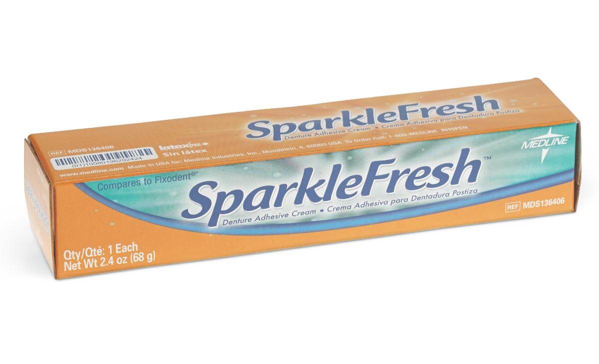 Denture adhesive cream box with orange and teal design, labeled SparkleFresh, 2.4 oz net weight