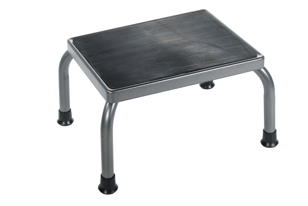 Footstool with silver steel frame, black ribbed non-skid rubber platform, and four rubber-tipped legs on white background