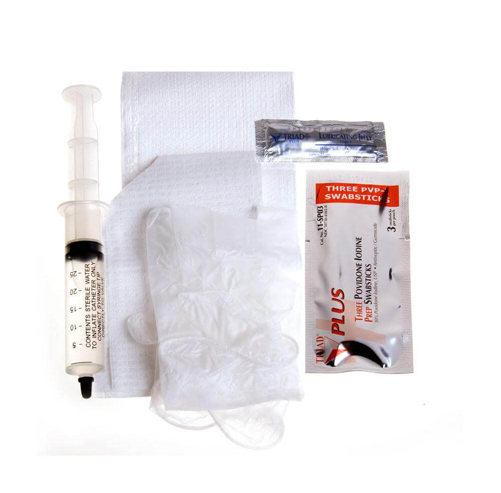 Foley catheter insertion tray kit with sterile syringe, lubricating jelly packet, PVP swabsticks, drape, and gloves on white