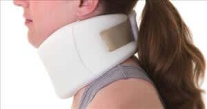 Firm cervical collar in white foam worn by a person shown from the side, securing the neck area
