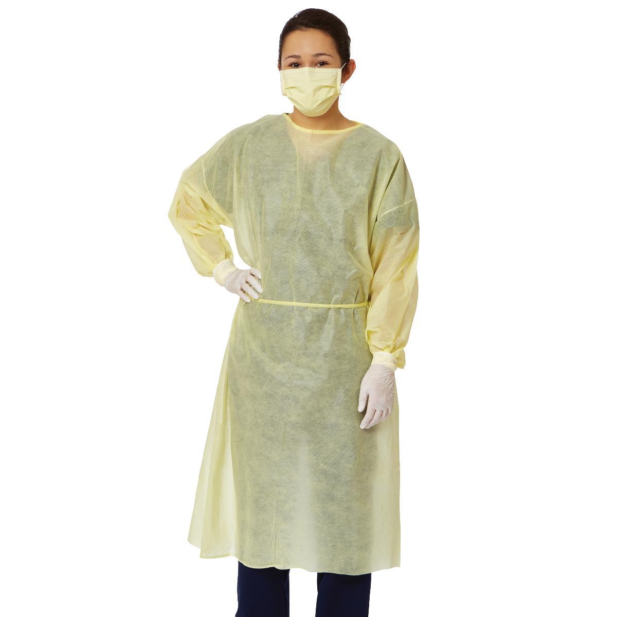 Disposable isolation gown in yellow worn by a model with matching face mask and white gloves, shown from the front