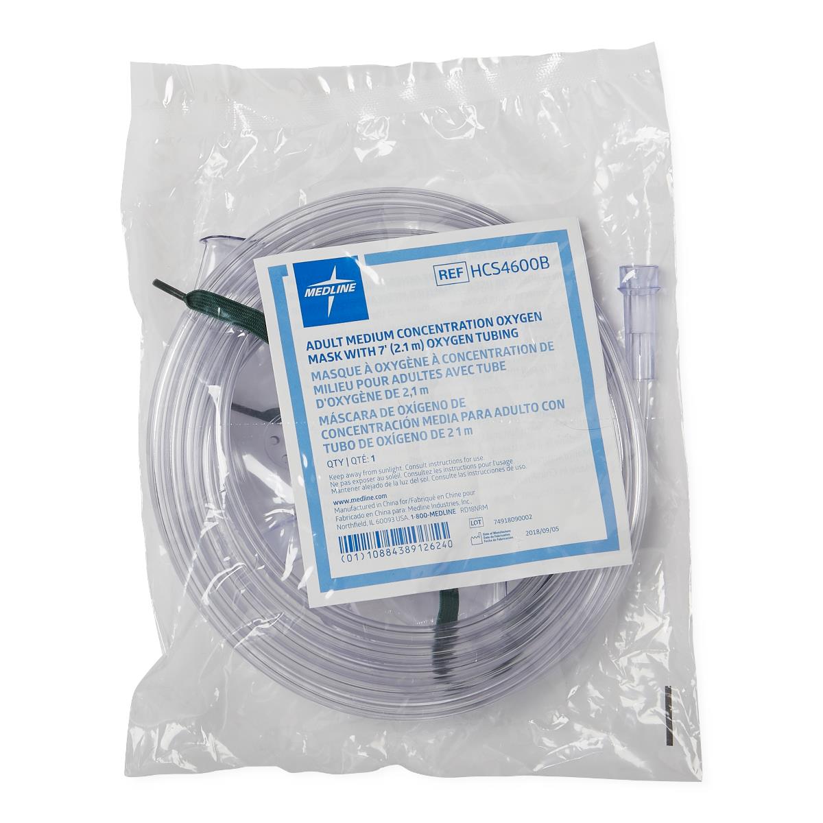 Oxygen mask with tubing coiled and sealed in clear plastic packaging with labeled product information card