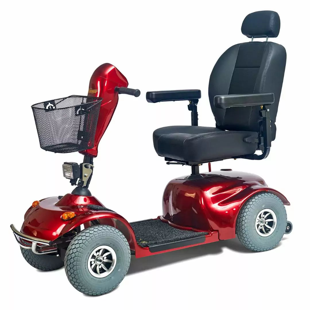 Four-wheel mobility scooter in red with black captain's seat, headrest, armrests, front wire basket, and large pneumatic