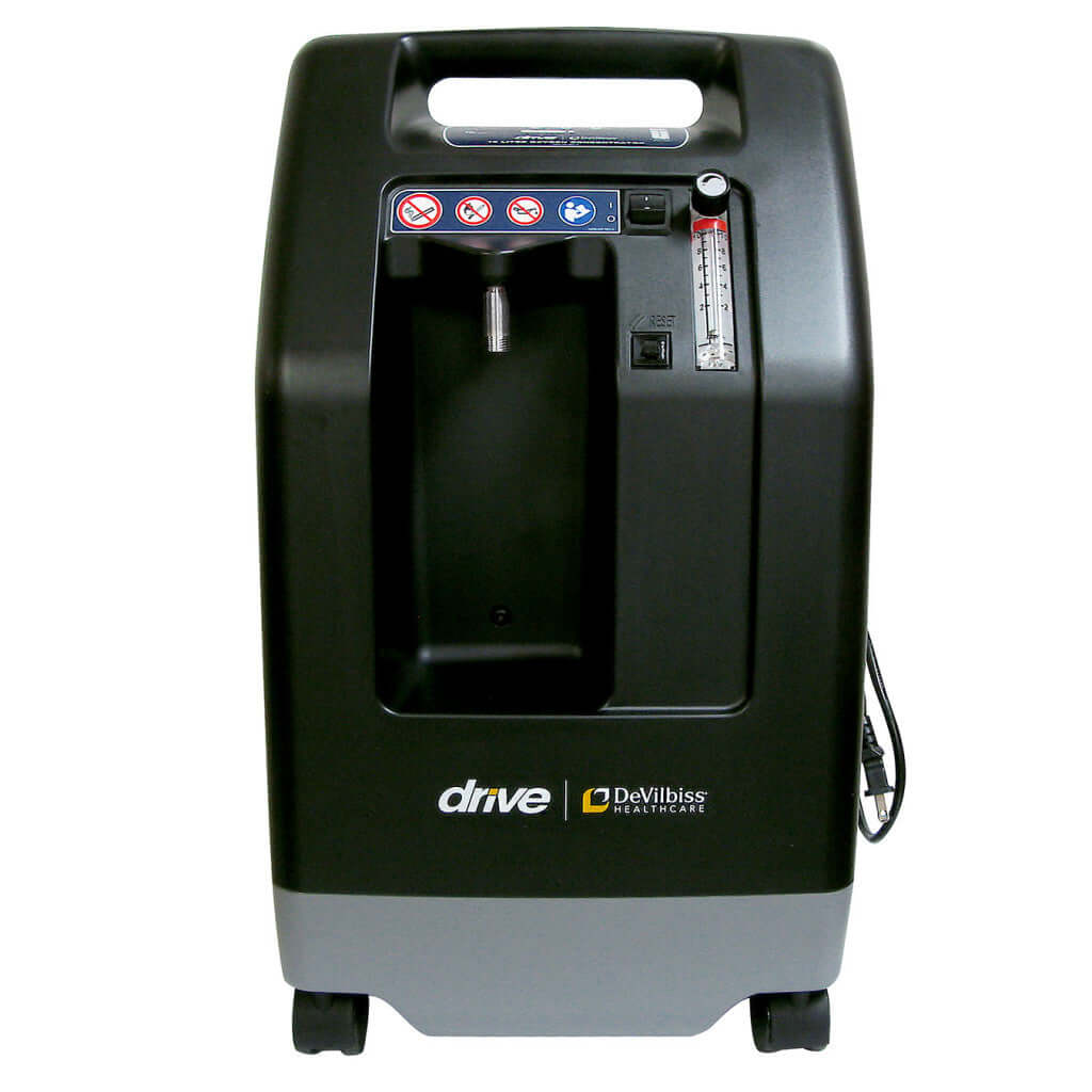 Oxygen concentrator by Drive DeVilbiss, black upright unit with carry handle, flow meter, warning labels, and wheeled base