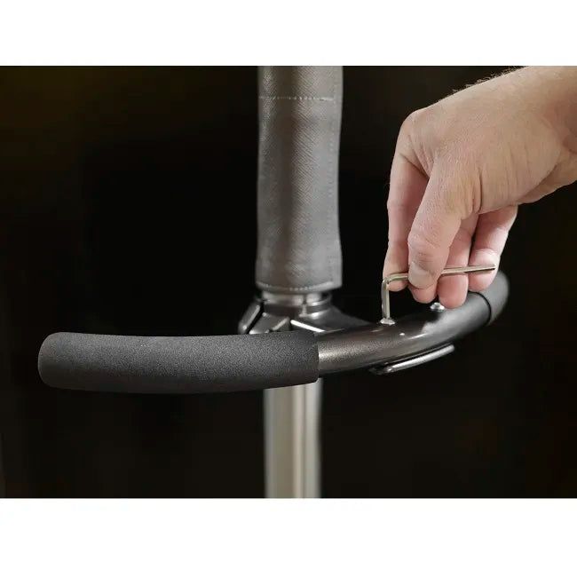Standing pole handle with foam grip and metal pin adjustment, shown with hand inserting locking pin into height mechanism