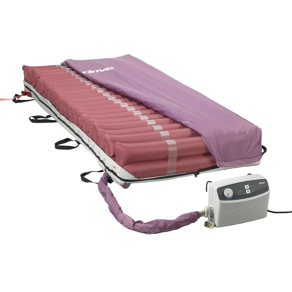 Alternating pressure mattress system with purple cover partially pulled back showing air cells, connected to a electric pump