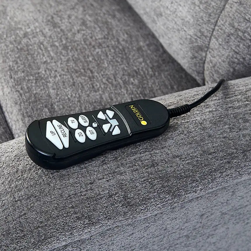 Lift chair hand control with labeled position buttons resting on gray upholstery, connected by a black cord