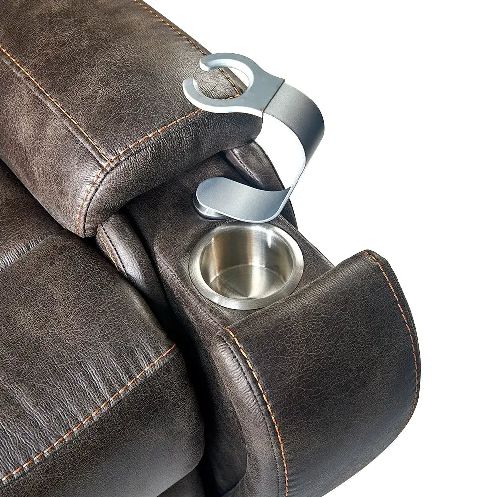 Lift chair armrest detail showing stainless steel cup holder and silver cane or accessory hook on brown faux leather