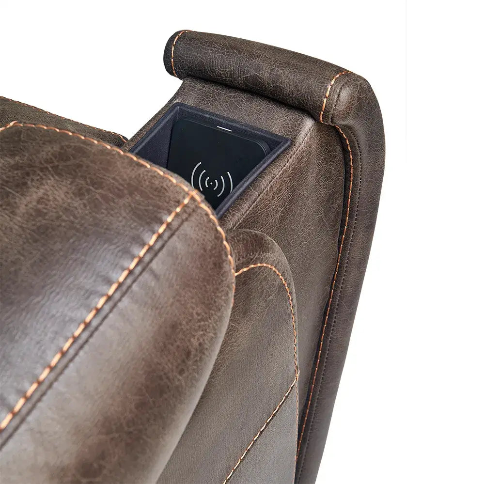Lift chair armrest close-up showing built-in wireless charging pad compartment with phone, brown faux leather with contrast