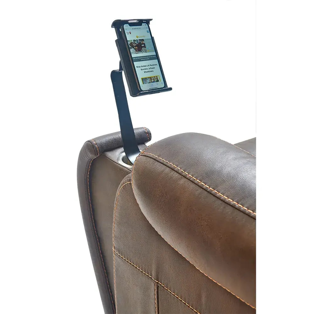 Tablet and phone holder mount clipped to the armrest of a brown leather lift chair, displaying a website on screen