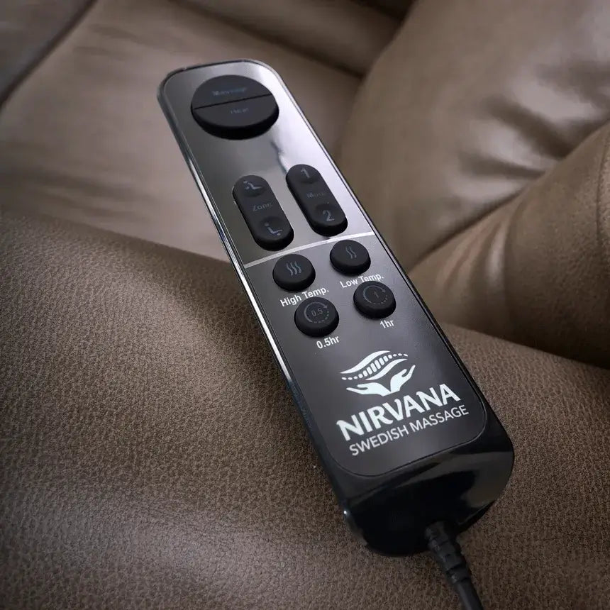 Lift chair wired hand control with zone, heat, and timer buttons resting on brown leather upholstery