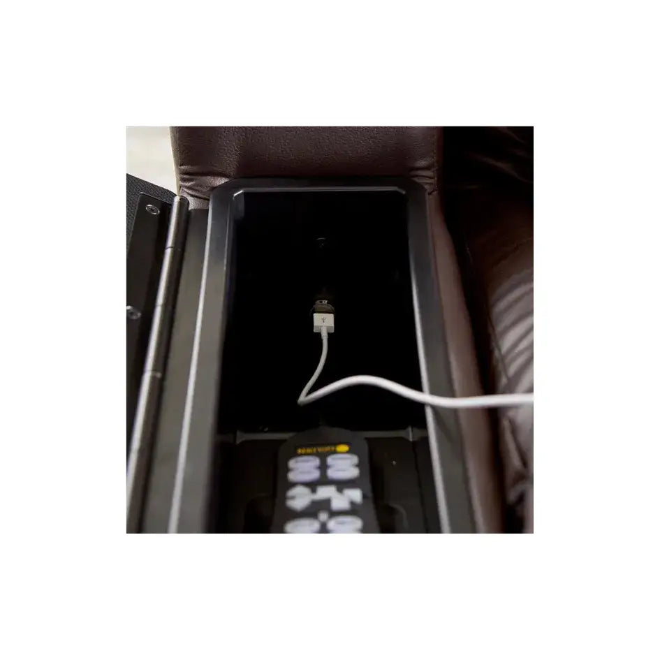 Power lift recliner side storage compartment showing built-in USB charging port with white cable and remote control inside